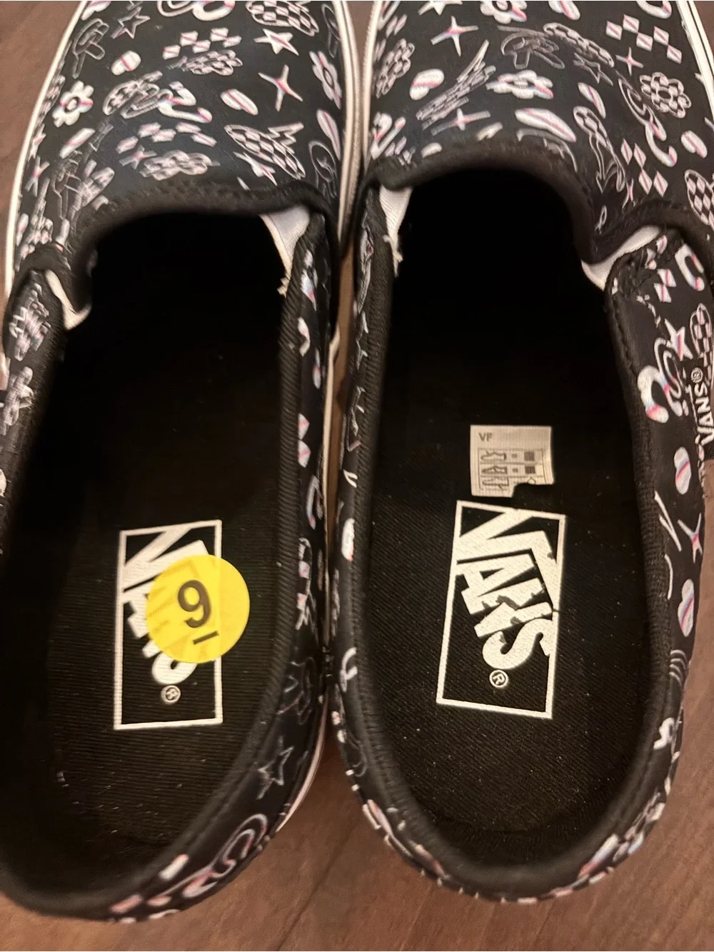 Vans Women’s Black Slip-On Sneakers with Multicolor Icon Accents